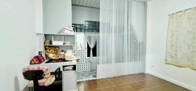 Cozy bedroom with well-organized shelves and elegant curtain