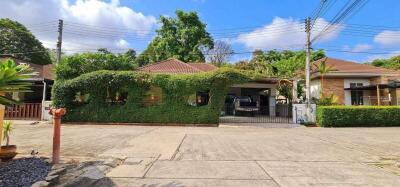 greenery-covered residential house with expansive parking