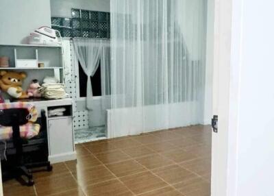 Spacious kitchen with large white shelving unit and tile flooring