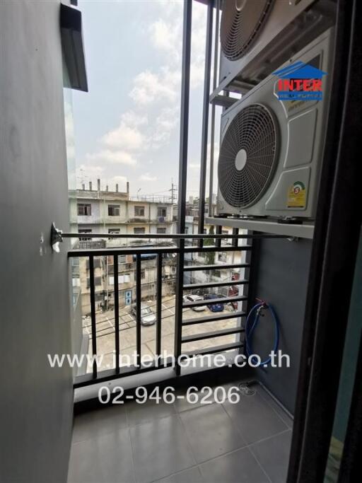 Compact balcony with an air conditioning unit overlooking the city