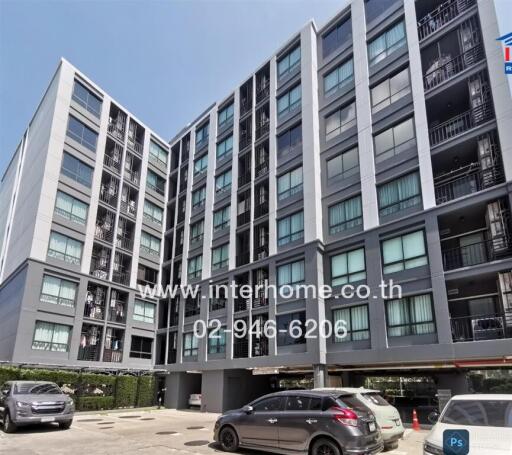 Modern residential building exterior with parked cars