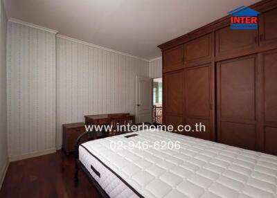 Spacious bedroom with large bed and classic furniture