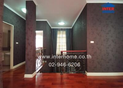 Elegant living room with decorative columns and hardwood floors
