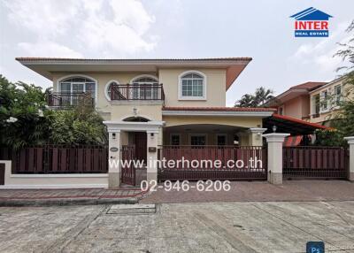Elegant two-story house with a balcony and secure gate