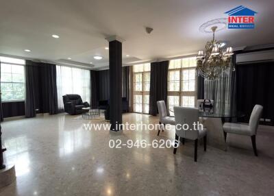 Spacious and elegant living room with large windows and luxurious decor