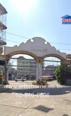 Exterior view of a commercial building with an archway entrance