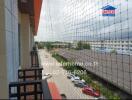 view from the balcony overlooking a parking area and several buildings