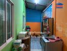 Compact kitchen area with vibrant walls and storage cabinets