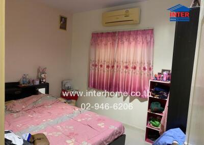 Cozy bedroom with pink curtains and air conditioning unit