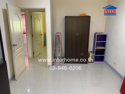 Spacious bedroom with wardrobe and shelving unit