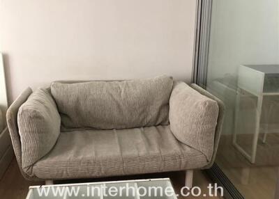 Compact living room with a sofa and white coffee table
