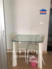 Modern small kitchen with glass dining table and two chairs