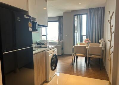 Modern compact kitchen and dining area with city view