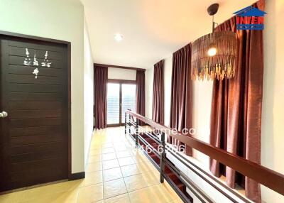 Elegant hallway with sophisticated lighting and warm curtains