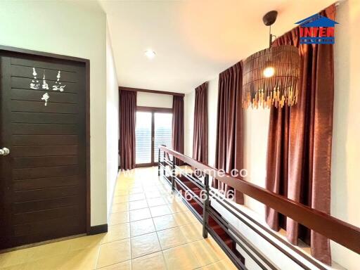 Elegant hallway with sophisticated lighting and warm curtains