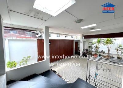 Spacious covered patio area with tile flooring and natural light