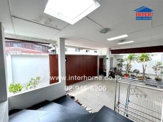 Spacious covered patio area with tile flooring and natural light