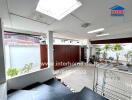 Spacious covered patio area with tile flooring and natural light