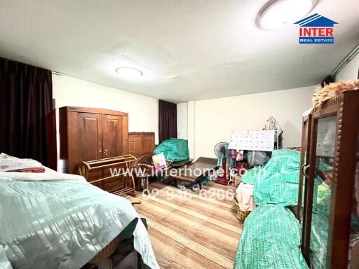 Spacious bedroom with multiple beds and wooden furniture