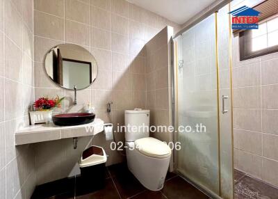 Modern bathroom with glass shower stall and elegant tiling
