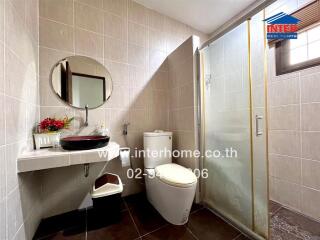 Modern bathroom with glass shower stall and elegant tiling