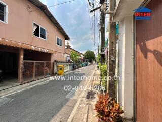 Exterior view of street with residential buildings and utility lines