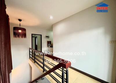 Spacious hallway with elegant chandelier and sleek railing