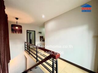 Spacious hallway with elegant chandelier and sleek railing