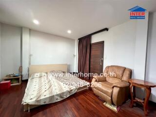 Spacious bedroom with wooden furniture and ample natural light