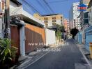 Urban street view with real estate signage and residential buildings