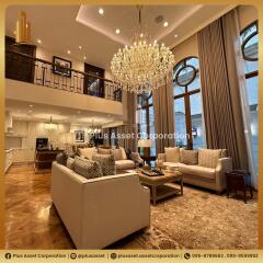 Elegant two-story living room with luxurious furnishings and chandelier