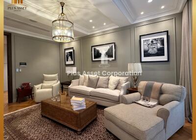 Elegant and spacious living room with modern furnishings and decorative lighting
