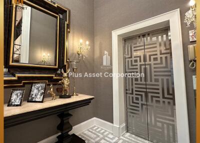Elegant foyer with decorative mirror and wall patterns