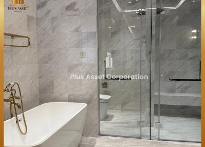 Luxurious modern bathroom with a freestanding bathtub and glass shower enclosure