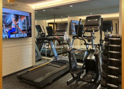 Well-equipped residential gym with modern machines and weights