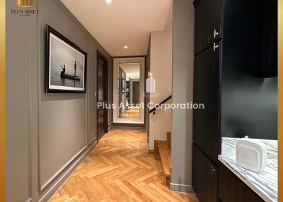 Elegant hallway in modern residential home featuring wooden flooring and stylish decor