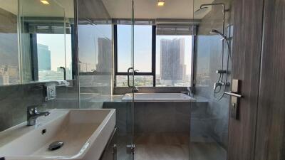 Modern bathroom with large windows and city view