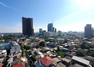 Panoramic cityscape view showcasing various buildings from high-rise to residential houses