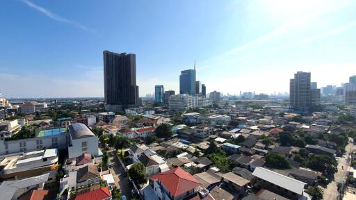Panoramic cityscape view showcasing various buildings from high-rise to residential houses