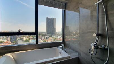 Modern bathroom with city view through large window