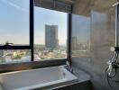 Modern bathroom with city view through large window