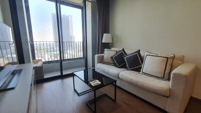 Spacious living room with large windows and city view