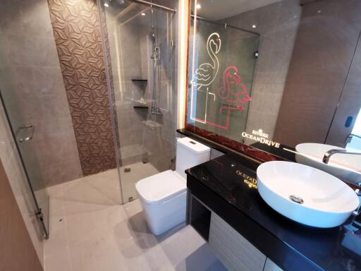 Modern bathroom with stylish decor and neon signs