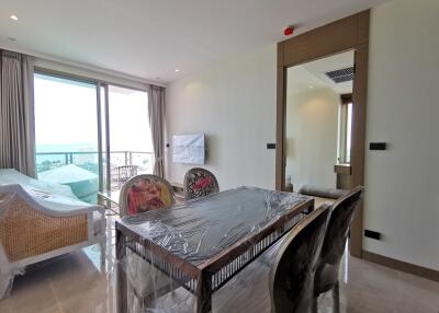 Spacious bedroom with sea view and dining area