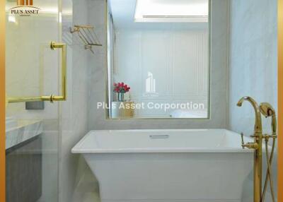Elegant bathroom with white bathtub and gold fixtures