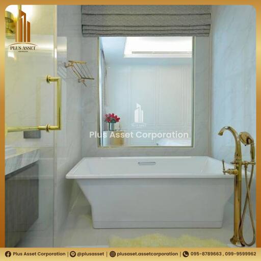 Elegant bathroom with white bathtub and gold fixtures