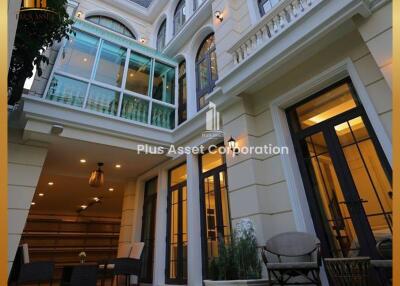 Luxurious two-story house with exterior lighting and multiple balconies