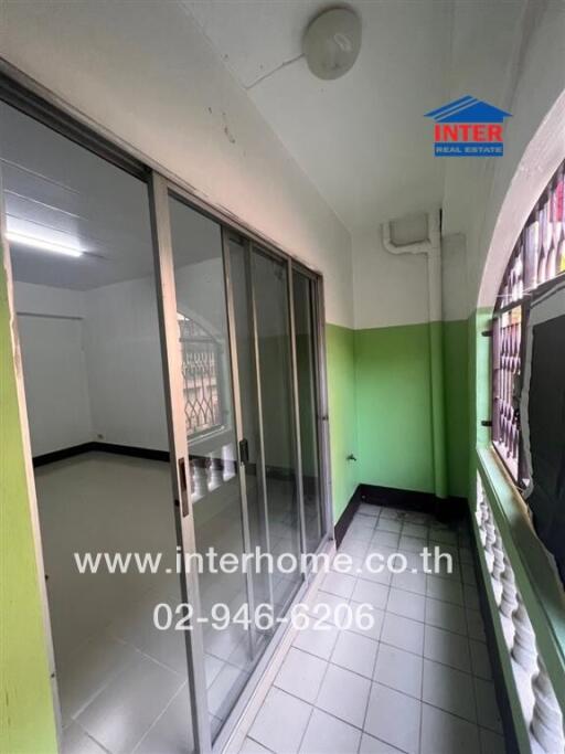 Compact kitchen space with sliding glass door and green flooring