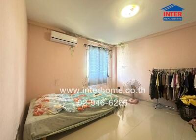 Spacious bedroom with natural light and air-conditioning unit