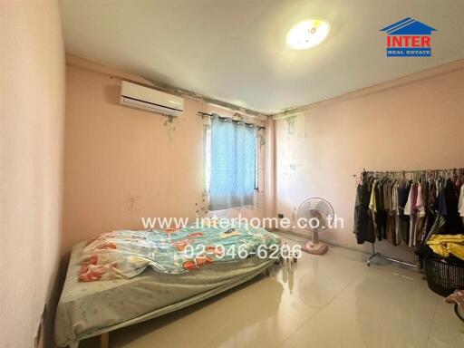 Spacious bedroom with natural light and air-conditioning unit
